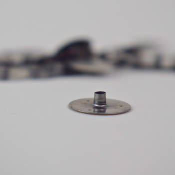 Metal baseplate for candle wick